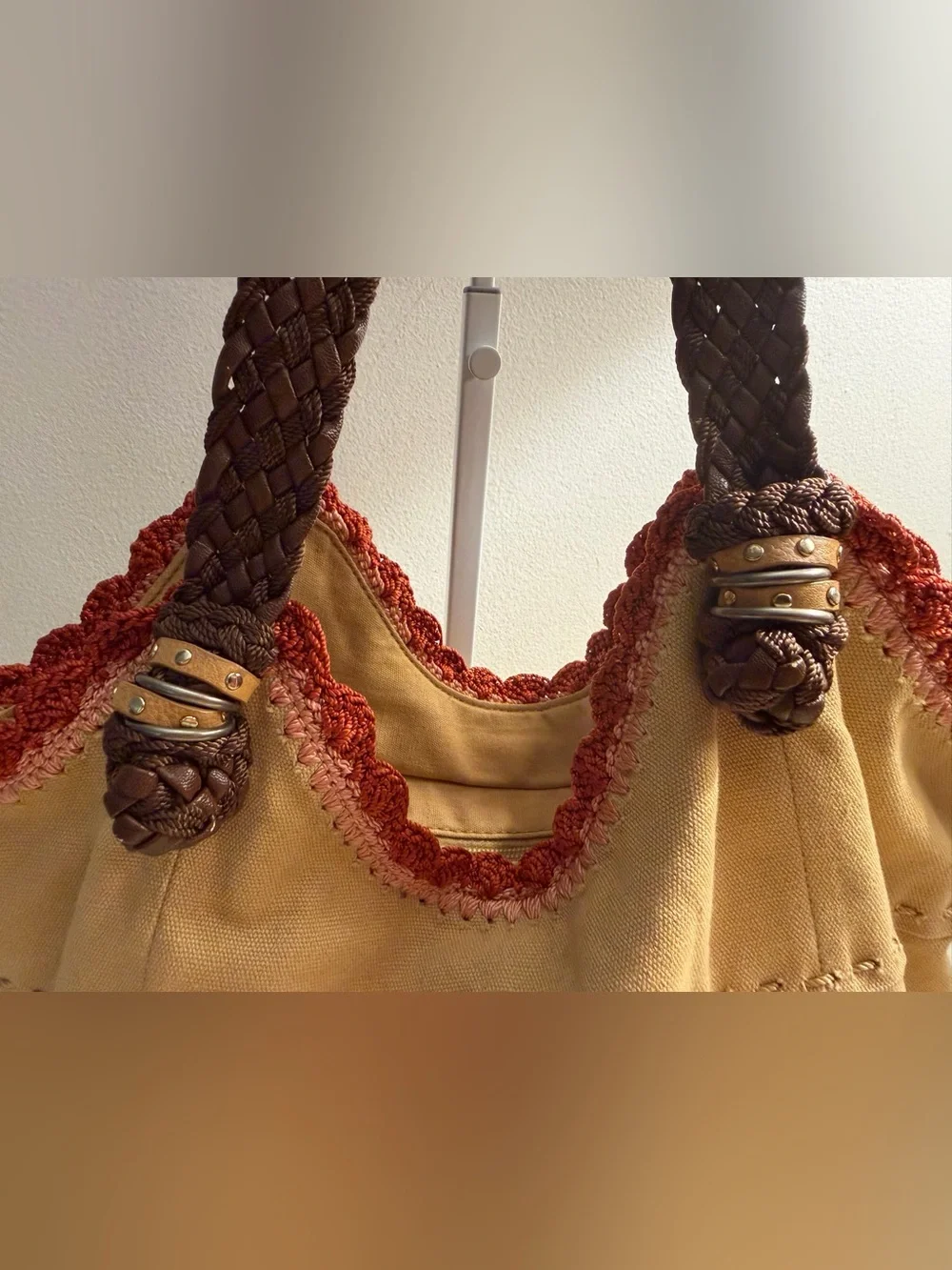 The Sak tan canvas Indio hobo bag with braided brown straps and crochet trim